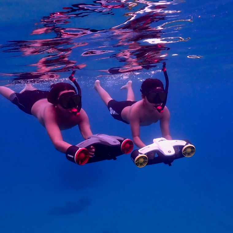 a man flying through the air while swimming in a body of water