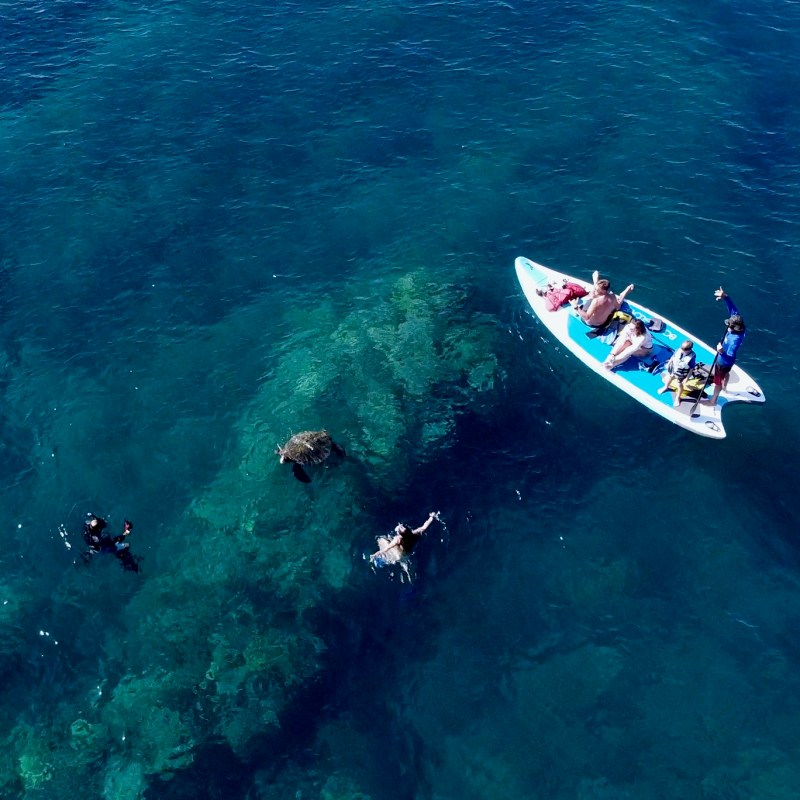 a man riding a wave on a surfboard in the water