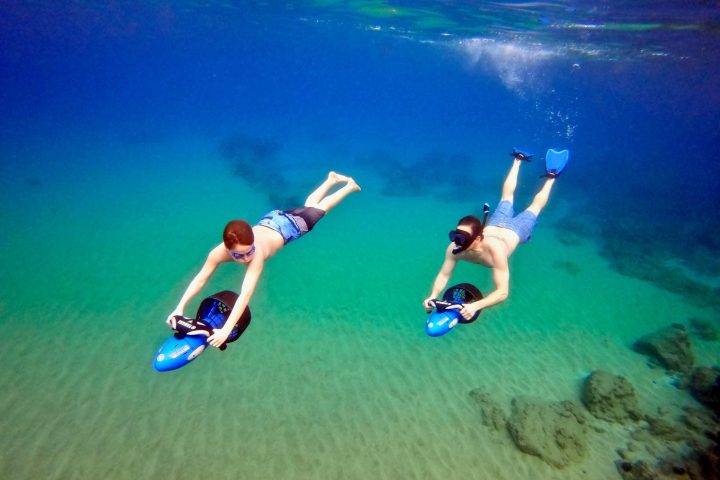 a man riding a skateboard down a pool of water
