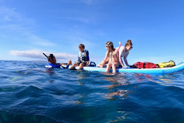 a man riding a wave on top of a body of water